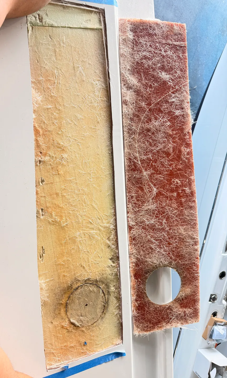 Fiberglass core cutout beside a replacement panel during hardtop structural repair