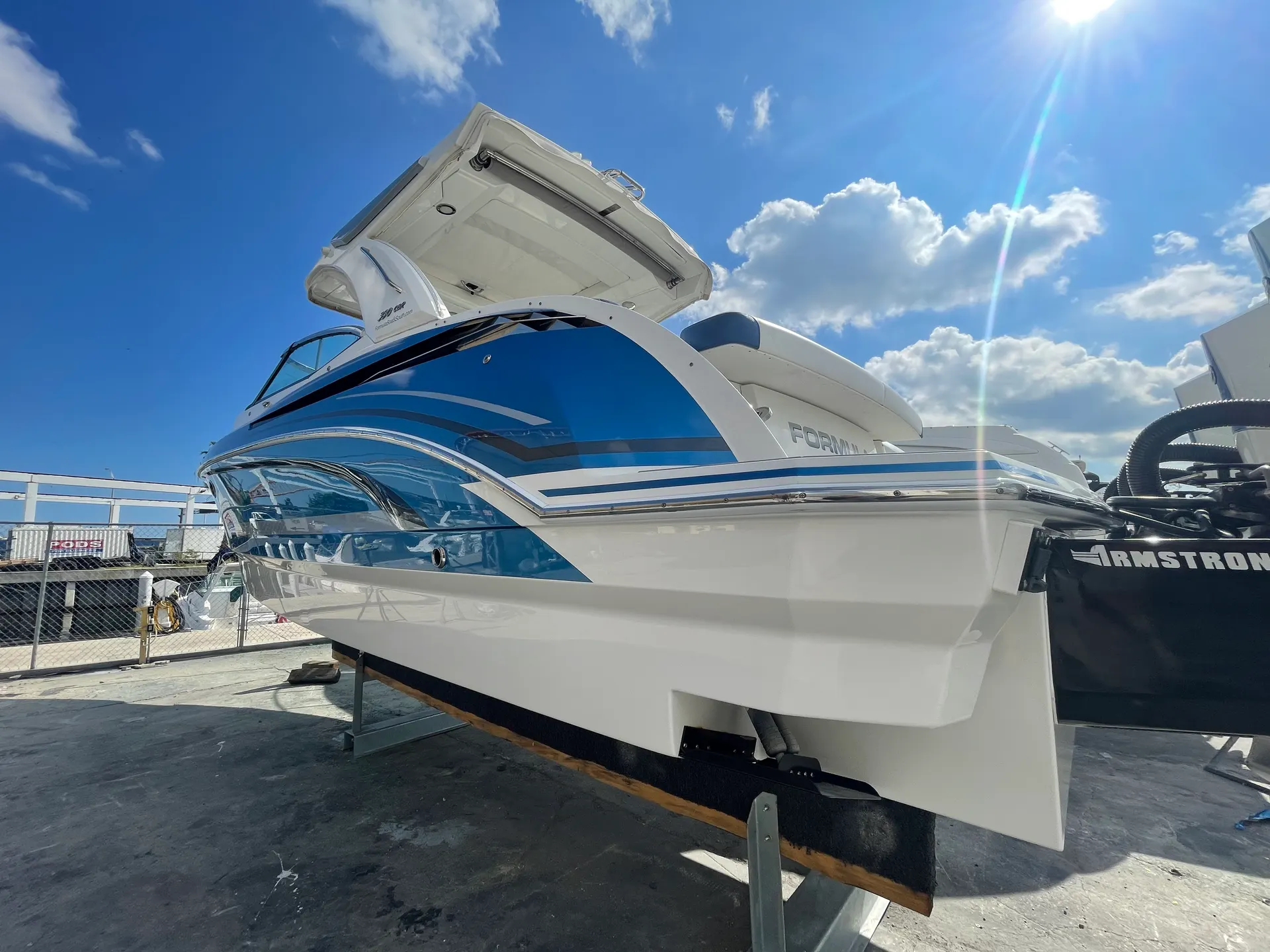 Stern of a Formula 330 CBR powerboat with a high-gloss blue hull finish after marine refinishing